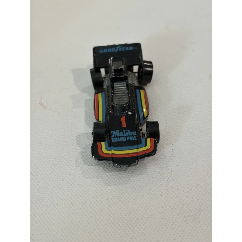 1982 Hot Wheels Malibu Grand Prix 1973 Malaysia Blackwalls Metal Base Black #1